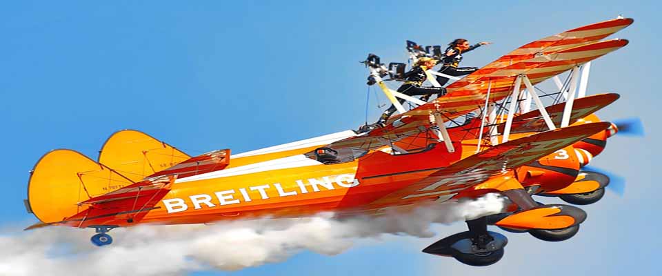 Image of the Brietling wing walkers performing aerobatic stunts with two aircraft